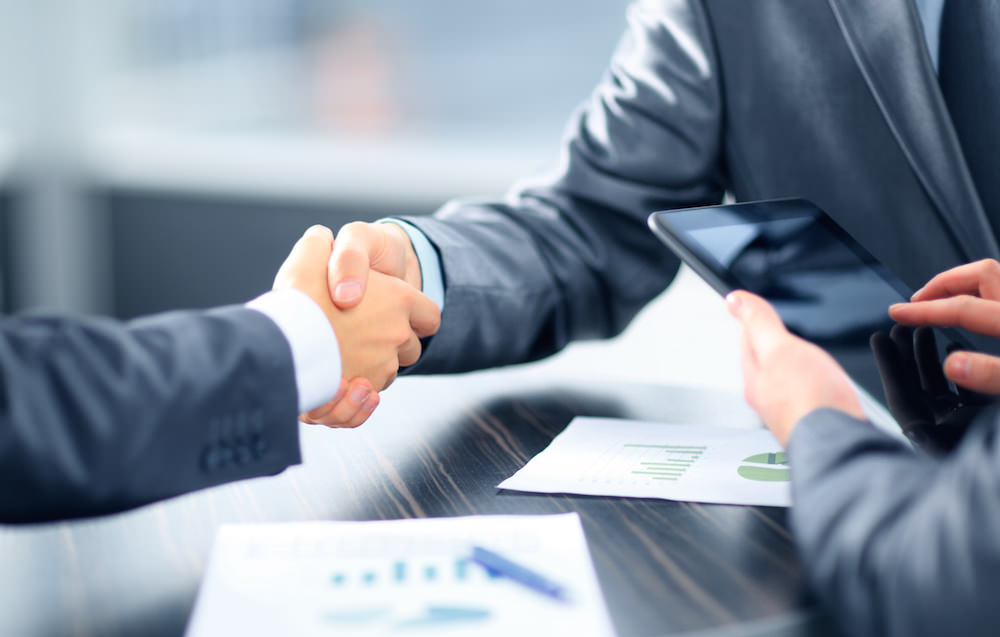 Business people shaking hands in office Business people shaking hands in office